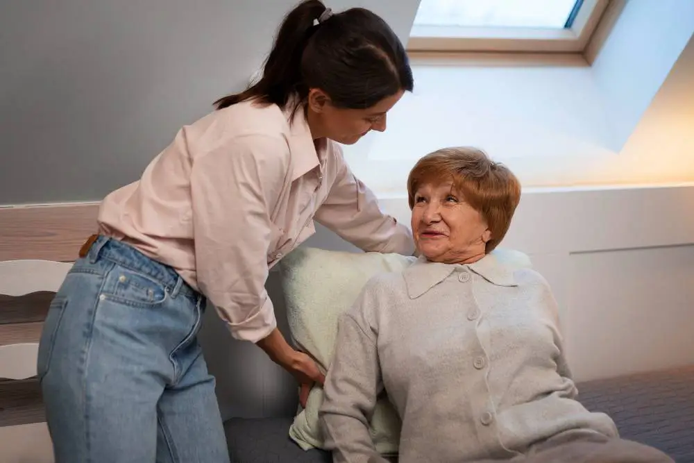 NYHC's Home Health Aide Service: Our home health aide assisting a patient to lie comfortably on the bed