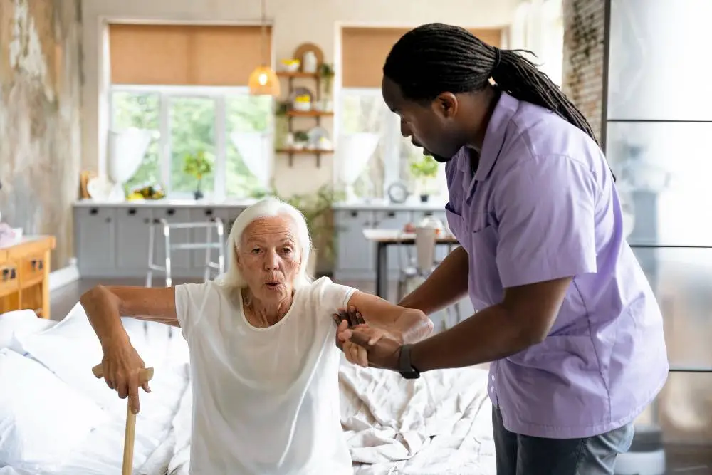 Diversity at NYHC's Home Health Aide Service: A caring home health aide, assisting an elderly patient to stand